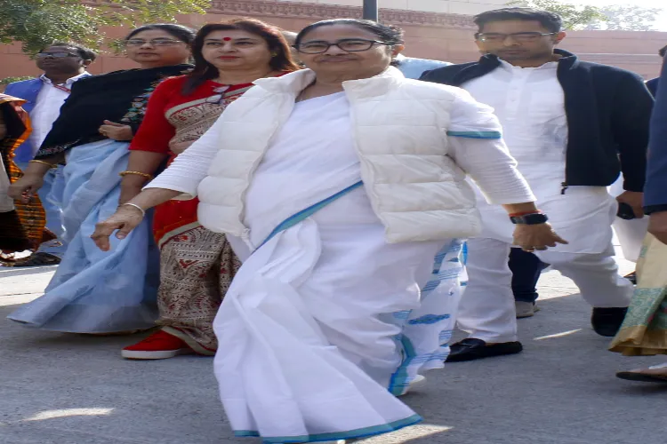 West Bengal Chief Minister and TMC supremo Mamata Banerjee with party MPs at the Parliament House Complex