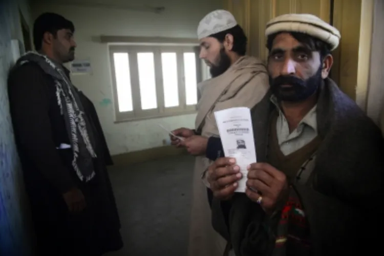 An Afghan refugee shows a token for registration card at National Database & Registration Authority in northwest Pakistan's Peshawar, on Jan. 11, 2018 (File photo)