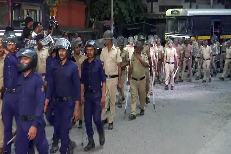 Police and security personnel conduct a flag march in the violence-hit area, in Nagpur on Tuesday.