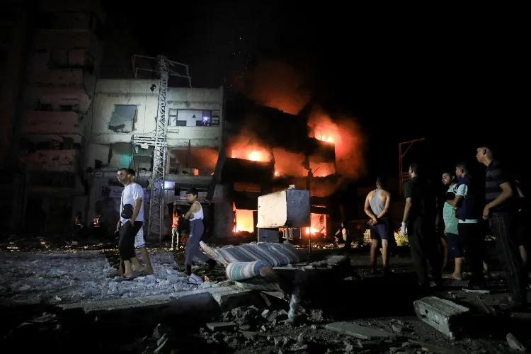 Palestinians gather at the site of an Israeli strike at a house amid the Israel-Hamas conflict, in Gaza City on Thursday. 