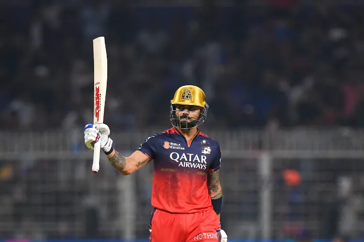 Royal Challengers Bengaluru's Virat Kohli celebrates his half century during the Indian Premier League cricket match between Kolkata Knight Riders and Royal Challengers Bengaluru at Eden Gardens in Kolkata on March 22, 2025.